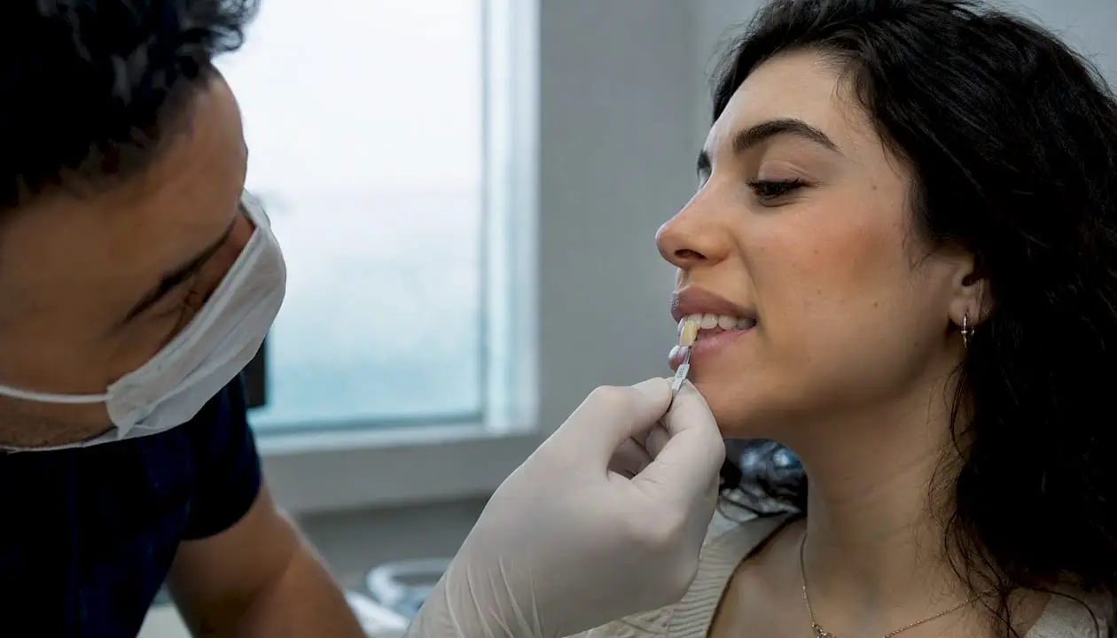 Dentist holding shade tab parallel to tooth
