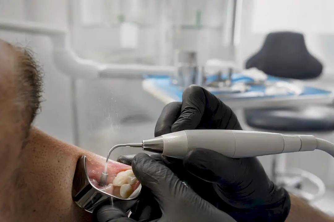 Clinician using ultrasonic tip on implant