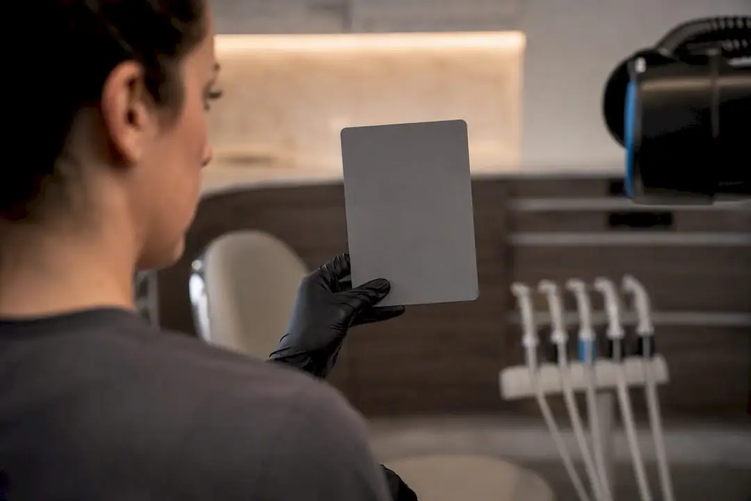 Clinician photographing gray card reference