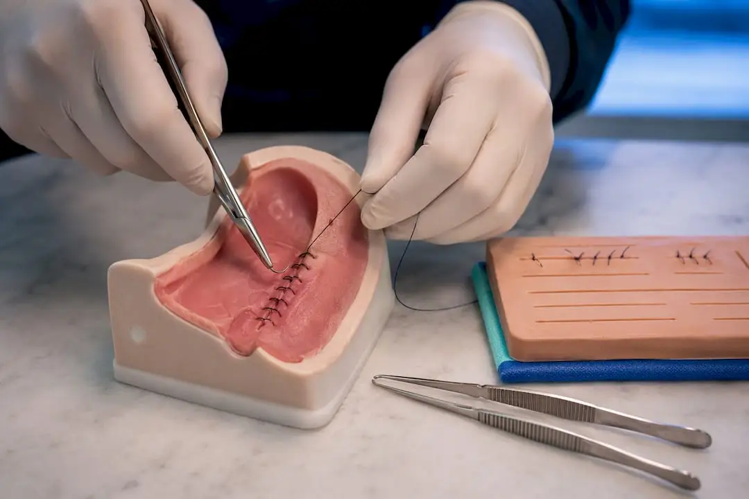 Dentist practicing suturing on simulation model